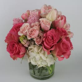 Pink and white rose bouquet in a glass vase