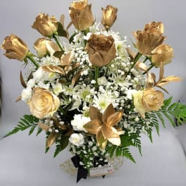 Bouquet of gold roses and white flowers with fern accents