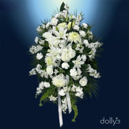 White floral standing spray with lilies, roses, and chrysanthemums