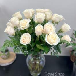 Cream roses arranged in a clear glass vase
