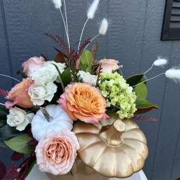 Pumpkin-shaped arrangement with roses, hydrangea, and white bunny tails
