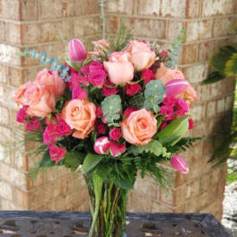 Pink and peach rose bouquet in a clear glass vase