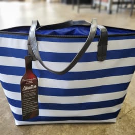 Blue and white striped tote bag with black handles and a hanging tag
