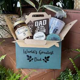 Gift basket with dad-themed snacks and grooming items in a teal box