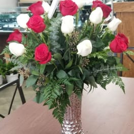 Red and white roses arranged in a silver vase