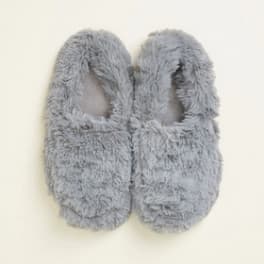 Pair of gray fuzzy slippers on a light background