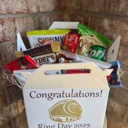 Gift box filled with assorted snack packs and a soda can