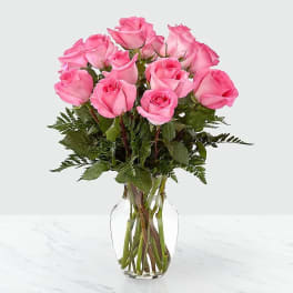 Pink roses arranged in a clear glass vase