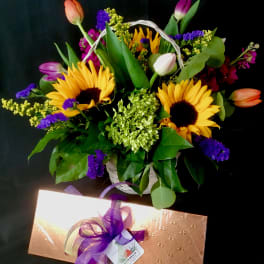 Basket of sunflowers and tulips with purple filler flowers