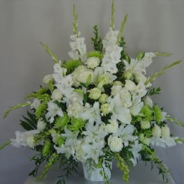 White floral arrangement with lilies and roses in a vase