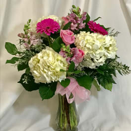 Pink and white mixed flower bouquet in a glass vase