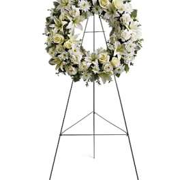 White floral wreath on a standing easel