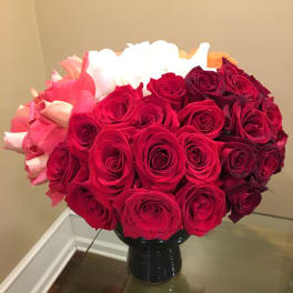 Bouquet of red and pink roses in a black vase