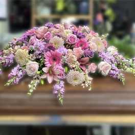 Casket spray of pink and lavender flowers