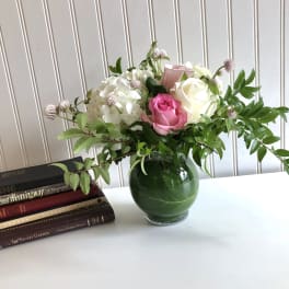Pink and white roses with hydrangea in a glass vase