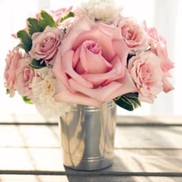 Pink rose bouquet in a silver tin vase