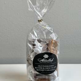 Bag of wrapped sea salt caramels with a black label