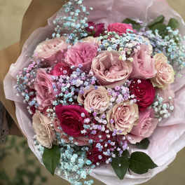 Bouquet of pink and red roses with pastel baby's breath