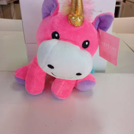 Pink plush unicorn toy with a gold horn and purple ears