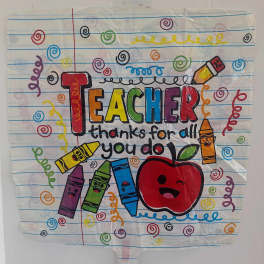 Teacher appreciation poster with crayons and an apple