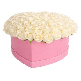 White roses arranged in a pink heart-shaped box