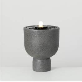 Gray textured candle holder with a lit candle