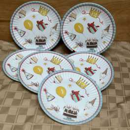 Five birthday-themed paper plates with cakes, balloons, and party hats