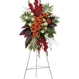Tall red and orange floral standing spray on an easel