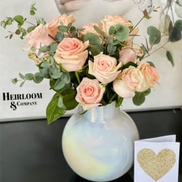 Blush roses in a white vase with a glitter heart card