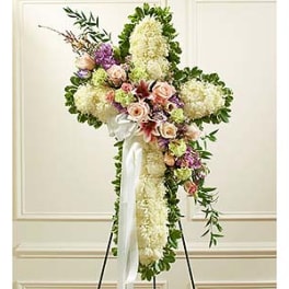 Standing floral cross with white and pastel flowers on an easel