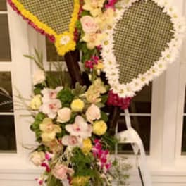 Standing floral display with two teardrop frames and pastel flowers