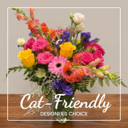 Colorful mixed bouquet in a clear glass vase with roses, gerbera daisy, and snapdragons