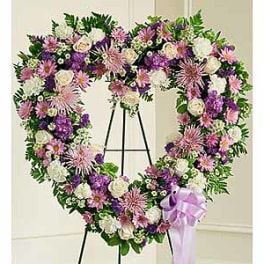 Heart-shaped floral wreath on an easel with a lavender ribbon