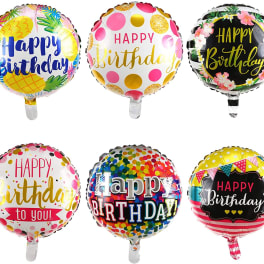 Six round birthday balloons with colorful printed designs