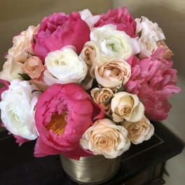 Bouquet of pink and cream peonies and roses in a metallic vase