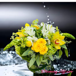 Yellow and white floral arrangement in a glass vase