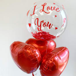 Heart-shaped balloons with a clear balloon reading "I Love You"