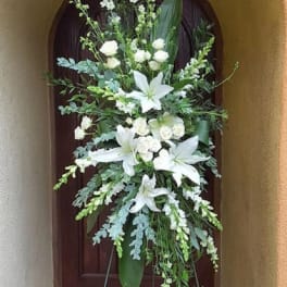 Tall white floral standing spray on an easel