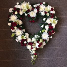 Heart-shaped floral wreath with red and white flowers