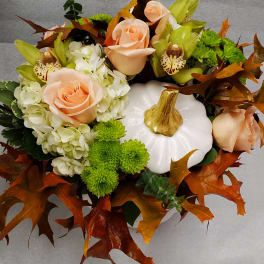 Pumpkin-shaped floral arrangement with peach roses and green orchids
