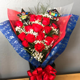 Bouquet of red roses with congratulatory picks and a red ribbon