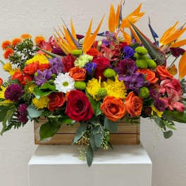 Colorful mixed flower arrangement in a wooden box