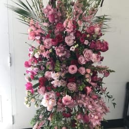 Tall pink floral standing spray with roses and orchids