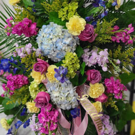 Colorful bouquet with hydrangeas, roses, and blue delphinium