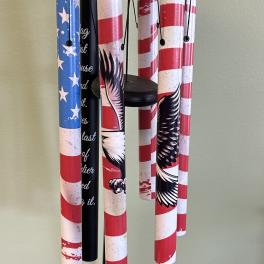 Patriotic wind chime with red, white, and blue tubes and an eagle medallion