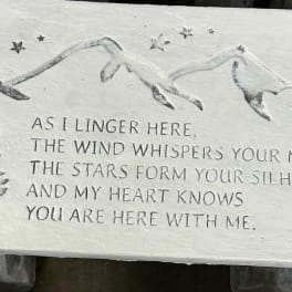Stone plaque with a mountain relief and engraved memorial text