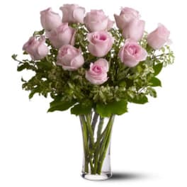 Pink roses arranged in a clear glass vase