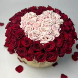 Heart-shaped rose arrangement with pale pink center and red outer roses