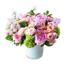 Pink and peach flower arrangement in a white vase