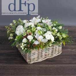 White floral arrangement in a wicker basket
